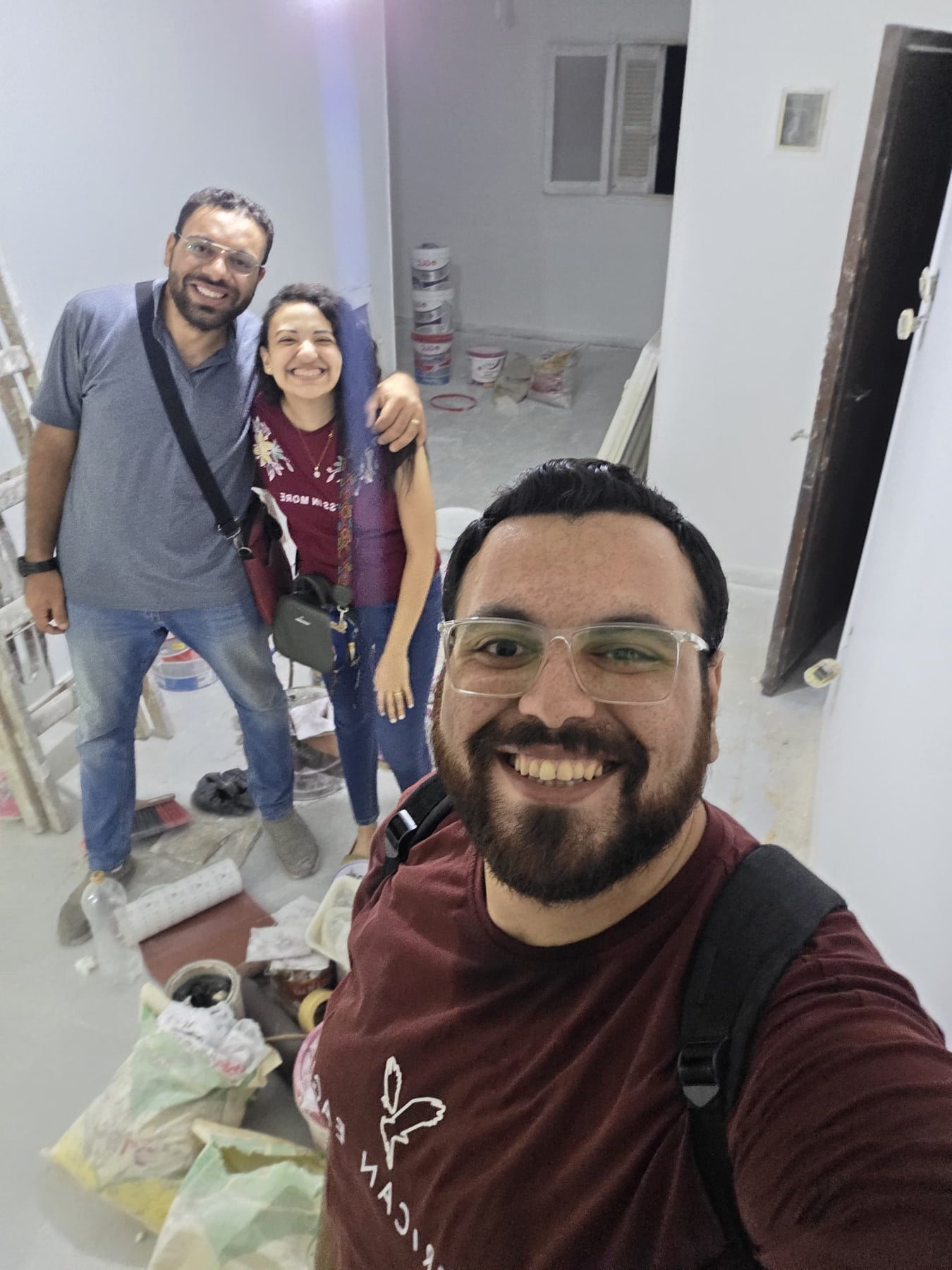 John taking a selfie with friends helping prepare the new home